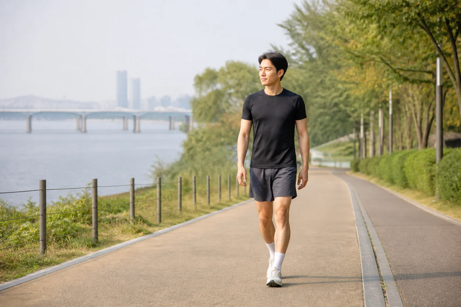 평탄한 한강공원 산책로에서 달리기를 멈추고 걷기 휴식을 하는 한국인 남성 러너